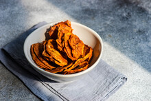Sliced, Dried And Dehydrated Persimmon Fruit In A Bowl