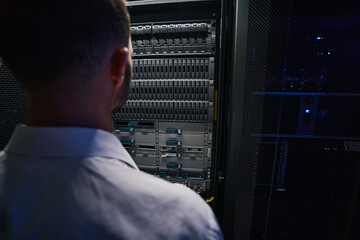 Wall Mural - Unrecognized bearded computer engineer examining telecommunications system in tech place