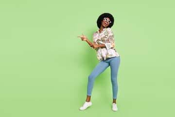 Sticker - Full body photo of young cheerful afro girl happy positive smile point fingers empty space dancer isolated over green color background