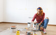 © BalanceFormCreative - Young red hair female preparing and mixing paint to  decorate walls in her new  home.