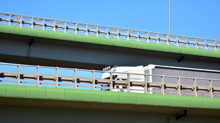 Bridge against the blue sky. Motorway flyover. Elevated roads on sunny day.