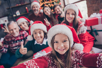 Wall Mural - Photo of wife husband retired pensioner married little small preteen school people xmas santa claus hat gesture make selfie indoors