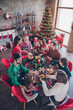 © deagreez - Vertical photo friendly family having festive christmas dinner on winter holidays indoors apartment