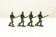 The Isolated Image Of A Group Of Green Plastic Toy Soldiers