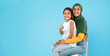 © Prostock-studio - Vaccinated Muslim Mother And Little Daughter Gesturing Thumbs-Up, Blue Background