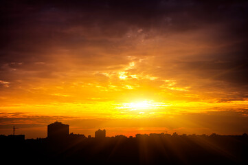 Wall Mural - Colorful sunset in the city. The silhouettes of the buildings.