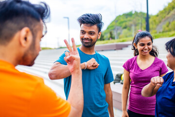 Wall Mural - funny eastern ethnic people exercising together outdoor