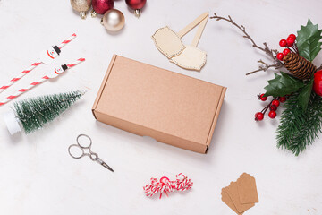 Cardboard box on wooden desk decorated with Christmas ornament