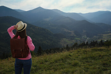 Canvas Print - Woman enjoying mountain landscape, back view. Space for text