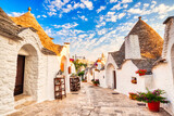 Fototapeta Miasta - Famous Trulli Houses during a Sunny Day with Bright Blue Sky in Alberobello, Puglia