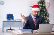 © Elnur - Young male employee celebrating Christmas at workplace