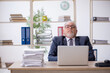 © Elnur - Old male employee and too much work in the office