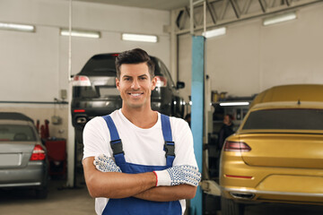 Wall Mural - Portrait of professional mechanic at automobile repair shop