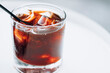 © Kaan - Cold brew with full of ice and black straw on a white background. Delicious cold beverage with coffee.