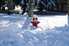 A Red Fire Hydrant Partially Buried In Snow