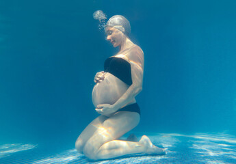 Wall Mural - Pregnant woman in the pool.