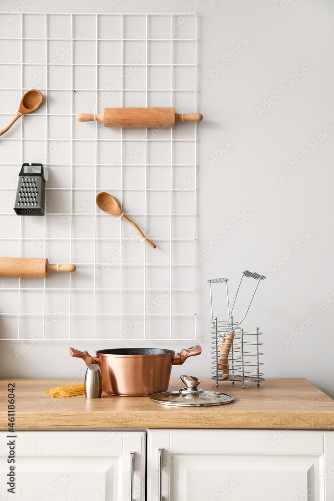 Copper cooking pot with saltcellar on counter in kitchen