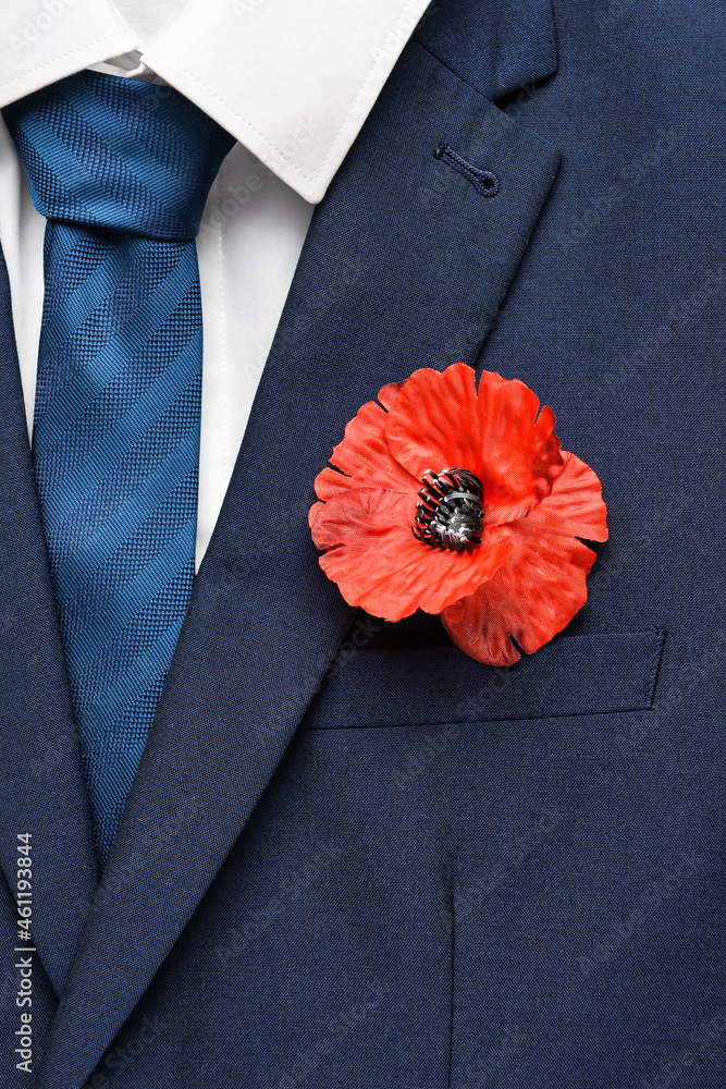 Poppy flower pinned on male clothes, top view. Remembrance Day