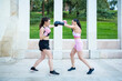 © luisrojasstock - boxing match between two young caucasian women outdoor