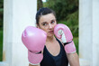 © luisrojasstock - portrait young caucasian female boxer with pink boxing gloves