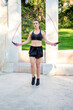© luisrojasstock - young caucasian female boxer training skipping rope in a park
