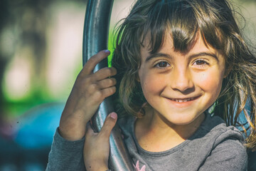 Poster - Happy young girl at the playground.