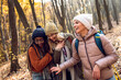 © Zoran Zeremski - Three female friends having fun and enjoying hiking in forest.