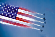 USA Air Forces Strike Concept. Fighter Aircrafts With American Flag Contrail