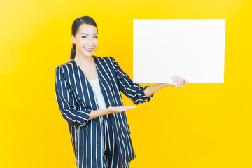 Wall Mural - Portrait beautiful young asian woman with empty white billboard