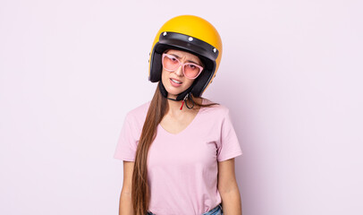 Poster - young pretty woman feeling puzzled and confused. motorbike rider and helmet