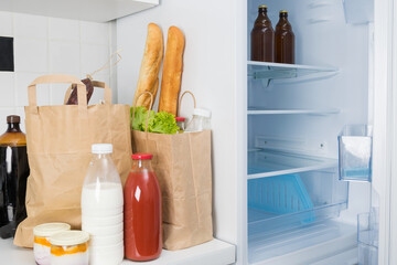 food and drinks in bags next to the refrigerator, home delivery