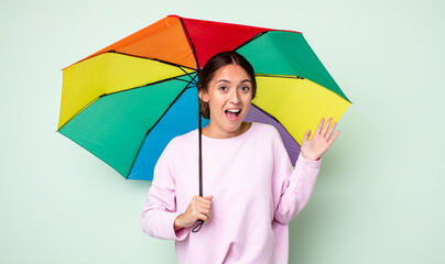 Poster - young pretty woman feeling happy, surprised realizing a solution or idea. umbrella concept