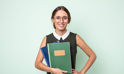 Poster - young pretty woman smiling happily with a hand on hip and confident. universitary concept