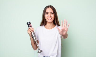 Poster - young pretty woman smiling and looking friendly, showing number five. hand mixer concept