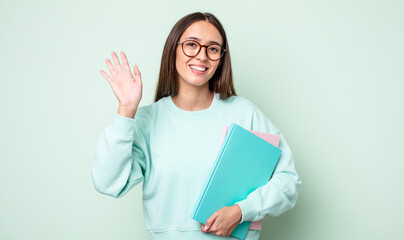 Poster - young pretty woman smiling happily, waving hand, welcoming and greeting you. universitary student