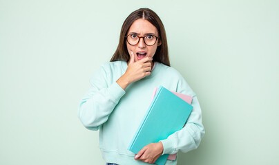 Poster - young pretty woman with mouth and eyes wide open and hand on chin. universitary student