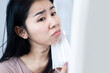 © doucefleur - Asian woman having a problem with acne and rash skin allergy under chin and face after wearing a protective mask