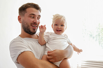 Wall Mural - Father and daughter spending quality time together. Bearded man with his adorable blonde toddler. Close up, copy space for text, background.