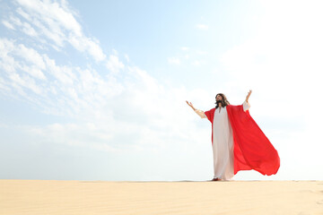 Jesus Christ raising hands in desert. Space for text