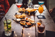 Blurred Background Of Multicolored Drinks And Minimal Food - Happy Hour Concept With Fancy Cocktails And Tasty Appetizers Served At Rooftop Lounge Prive - Warm Vintage Filter On Shallow Depth Of Field