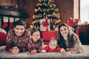 Sticker - Portrait of beautiful cheerful family lying on carpet rest festal time eve at modern loft industrial interior style indoors