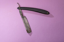 Antique Old Cut Throat Or Straight Razor On A Pink Background .