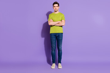 Poster - Full size photo of nice young brunet guy crossed arms wear t-shirt jeans sneakers isolated on violet background