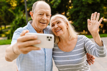 Wall Mural - Happy senior couple with smartphones