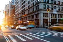 Busy Intersection On 5th Avenue And 23rd Street In New York City With Rush Hour Traffic Driving Into The Sunset