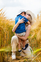 Sticker - happy mom with son hugging on wheat field