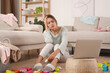 © New Africa - Tired young mother sitting on floor in messy living room