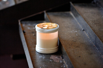 Wall Mural - Closeup shot of a burning candle on a staircase