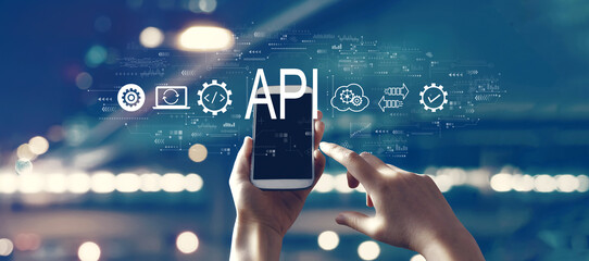 API - application programming interface concept with person using a smartphone