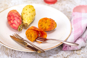 Sticker - Closeup shot of fresh prickly pears, cut in half in the white plate